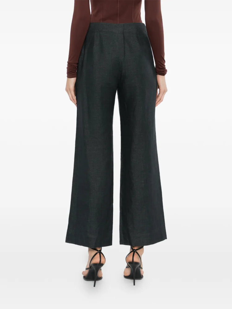 Charcoal linen wide-leg trousers by Chanel, showcasing relaxed fit and tailored design, with pleats and side pockets.