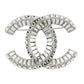 Chanel crystal pin brooch with sparkling gemstone accents and elegant design, shown from the front view.