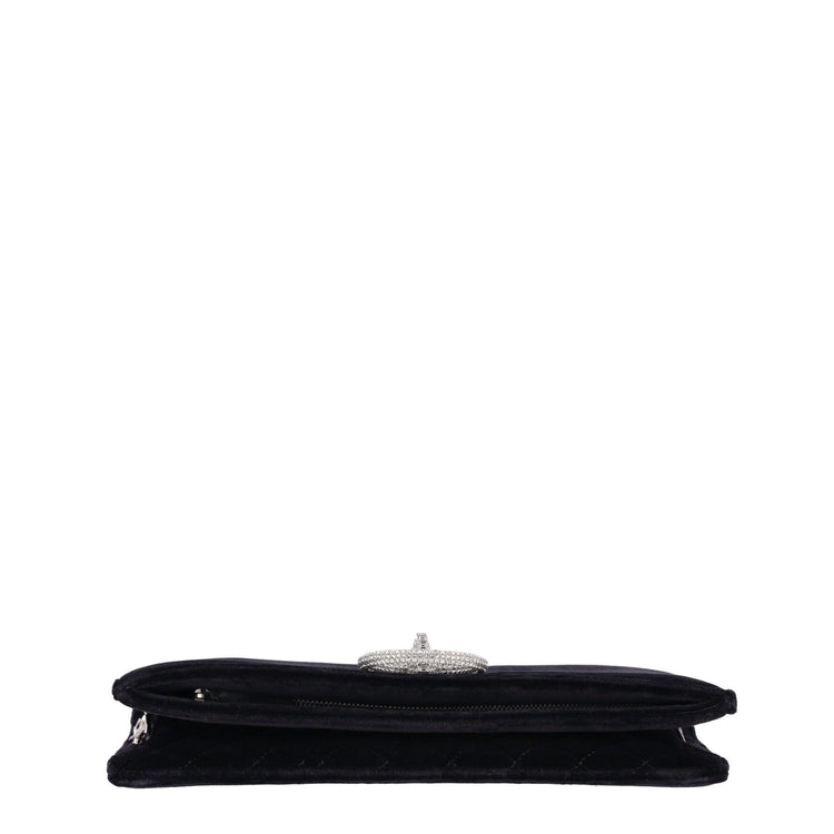 Chanel black velvet clutch shown open with diamond quilted interior