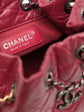 Chanel Gabrielle red backpack, side view on plain background
