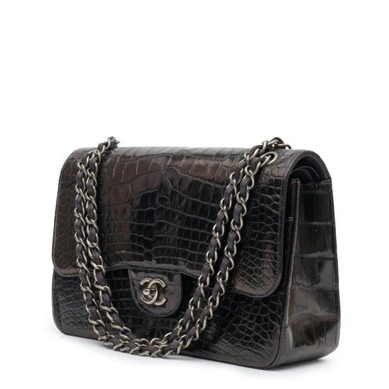 Side view of a Chanel Jumbo Double Flap Shoulder Bag showing its classic quilted leather design and gold chain strap.