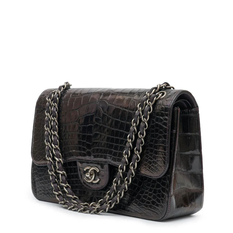 Side view of a Chanel Jumbo Double Flap Shoulder Bag showing its classic quilted leather design and gold chain strap.