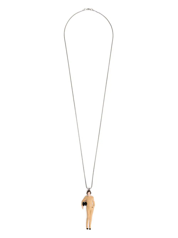 Chanel Keira Knightley doll pendant necklace with a gold chain and detailed doll charm, elegant jewelry accessory.