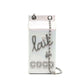Chanel Lait de Coco Milk Carton Bag in metallic silver with structured carton shape, top handle, chain strap, pearl-style lettering and novelty runway design.