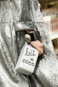 Chanel Lait de Coco Milk Carton Bag in metallic silver with structured carton shape, top handle, chain strap, pearl-style lettering and novelty runway design.