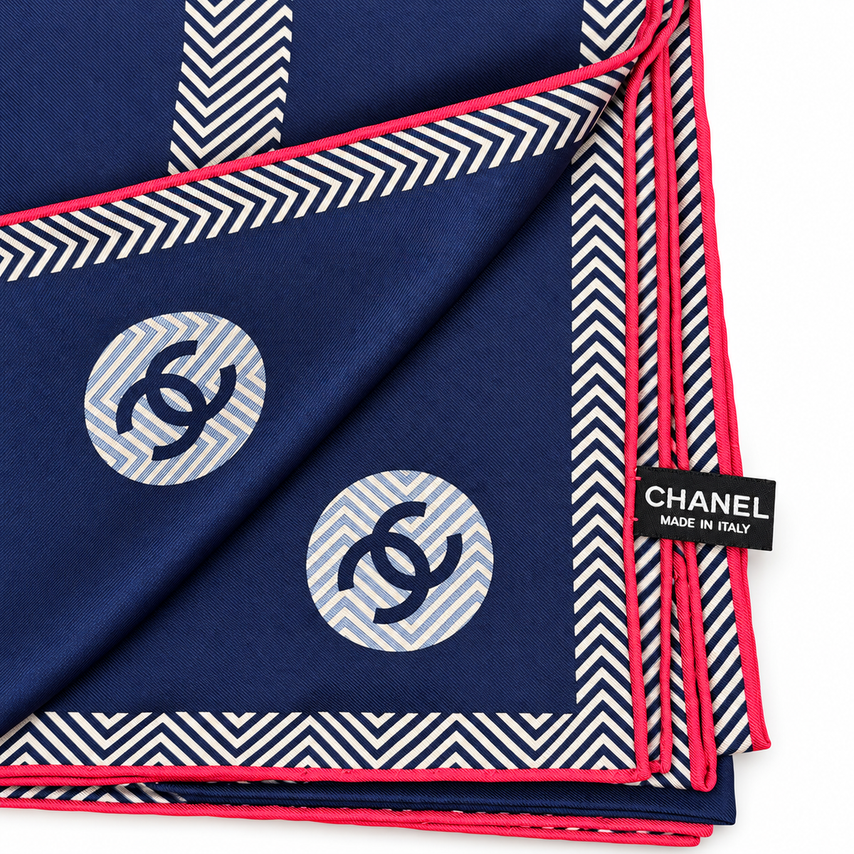 Navy Chanel silk scarf with pink trim and CC logo design, featuring elegant, smooth fabric and detailed branding.