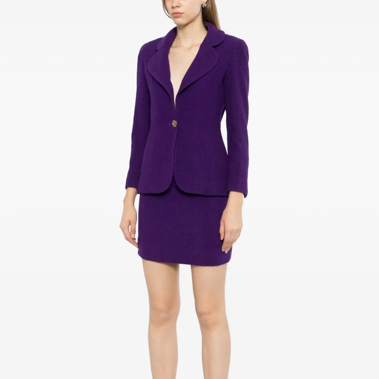 Purple Chanel single-breasted tweed suit set featuring tailored blazer and matching skirt for a classic, sophisticated look.