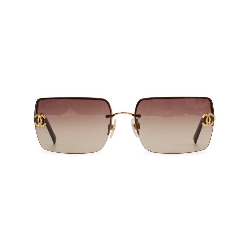 Chanel rimless rhinestone sunglasses with sparkling embellishments and sleek design, showcasing stylish eyewear.