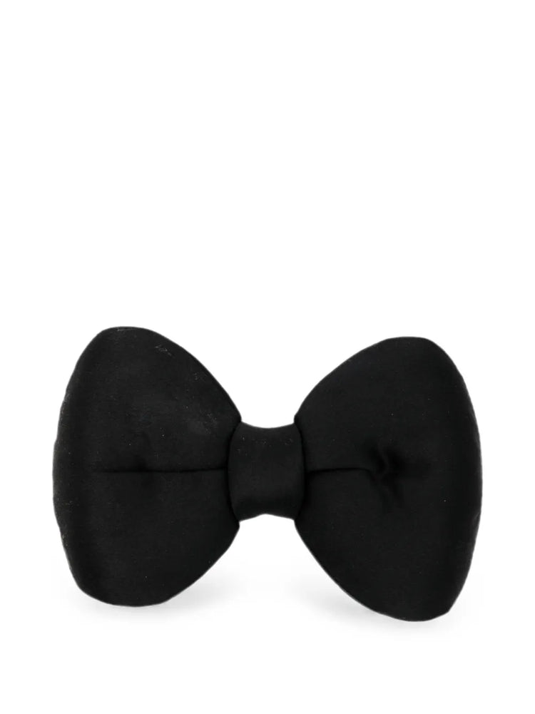 Chanel satin bow brooch featuring a sleek, elegant design with a shiny satin finish and classic bow shape.