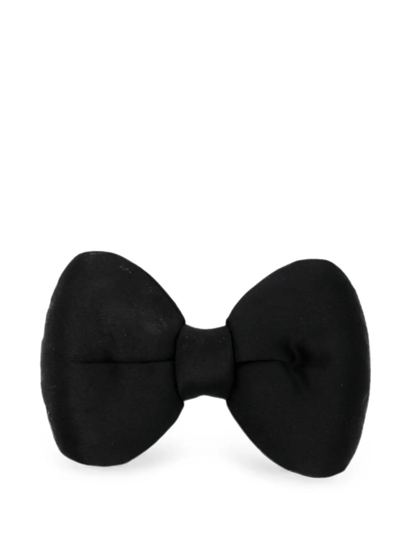 Chanel satin bow brooch featuring a sleek, elegant design with a shiny satin finish and classic bow shape.