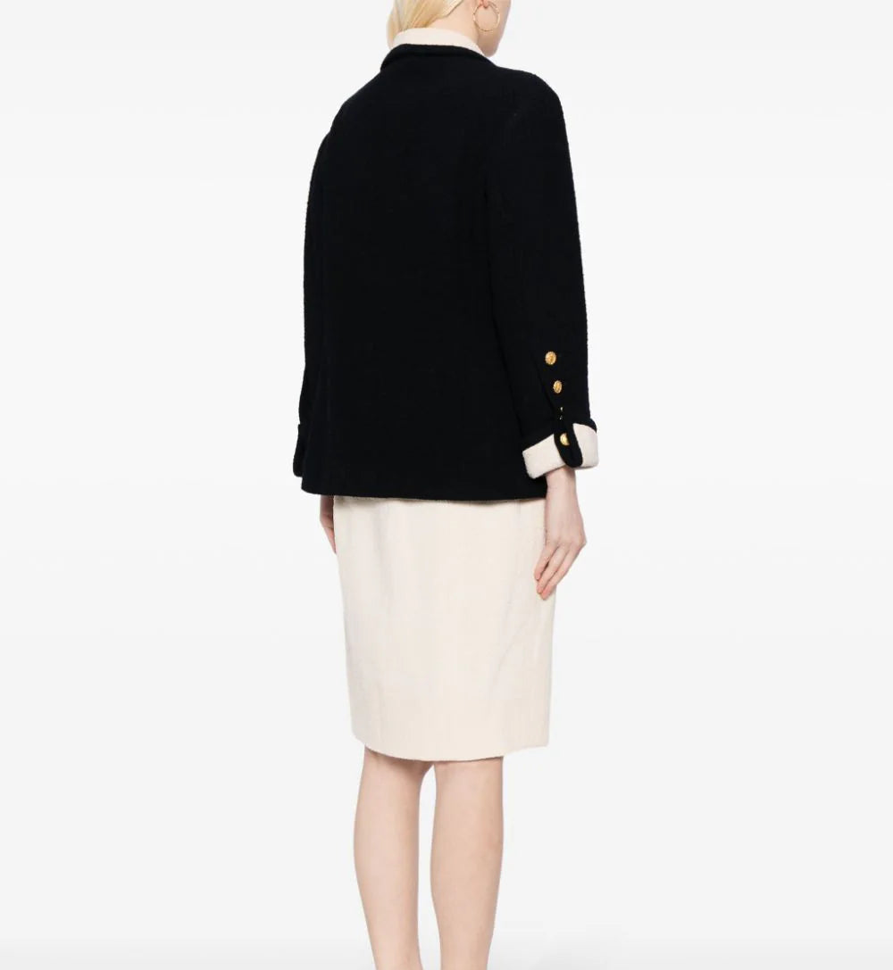 Chanel single-breasted bouclé skirt suit set featuring a tailored blazer and matching skirt, elegant and classic design.