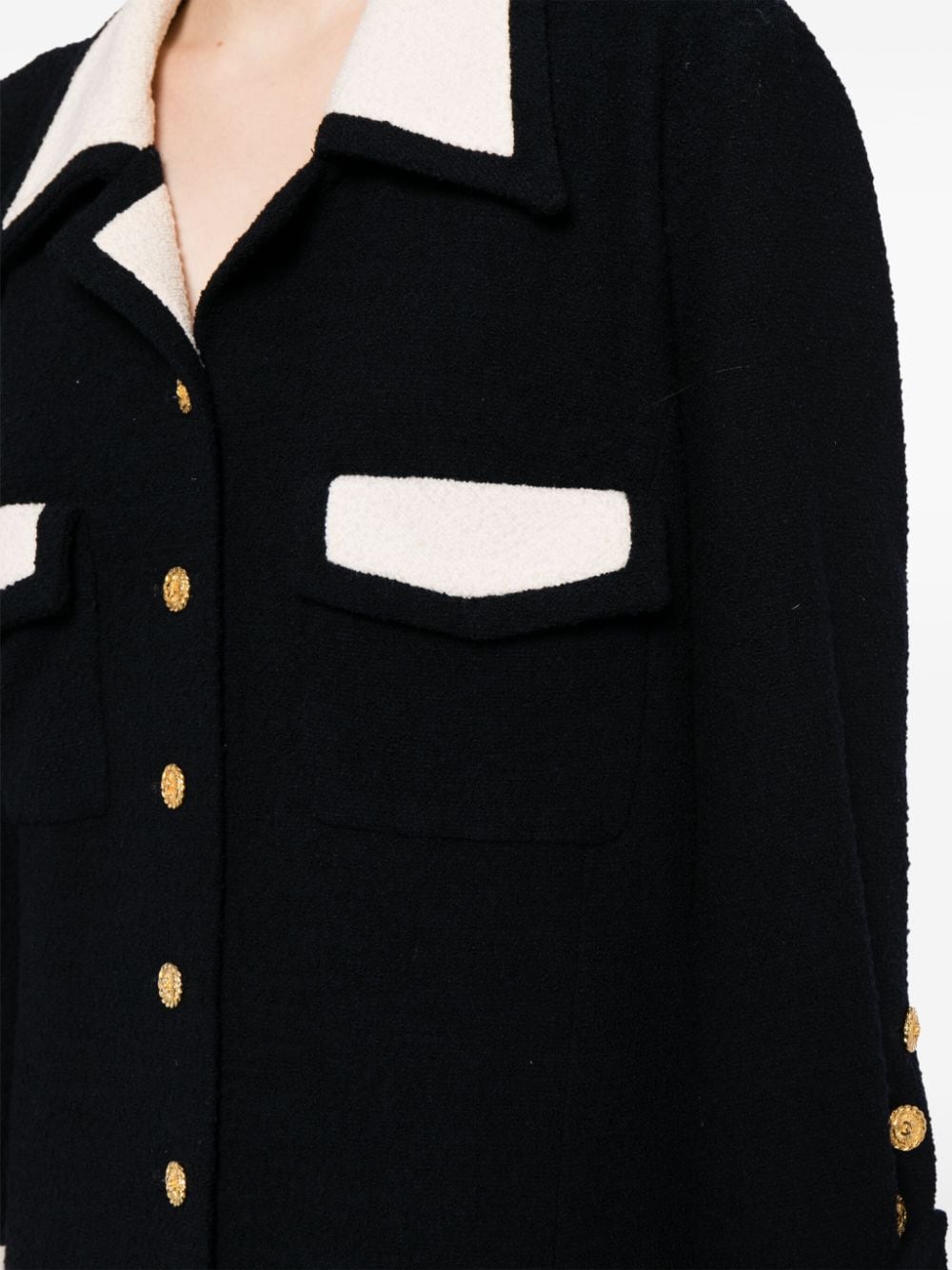 Chanel single-breasted bouclé skirt suit set with matching blazer and skirt, elegant and classic fashion ensemble.