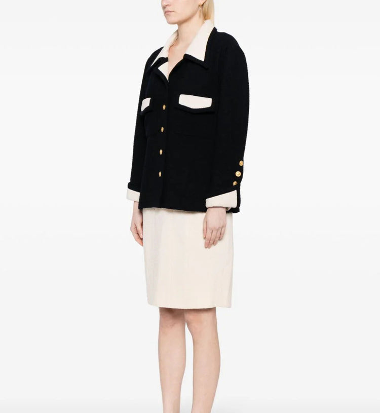 Chanel single-breasted bouclé skirt suit set featuring tailored blazer and matching skirt, elegant and classic luxury fashion.