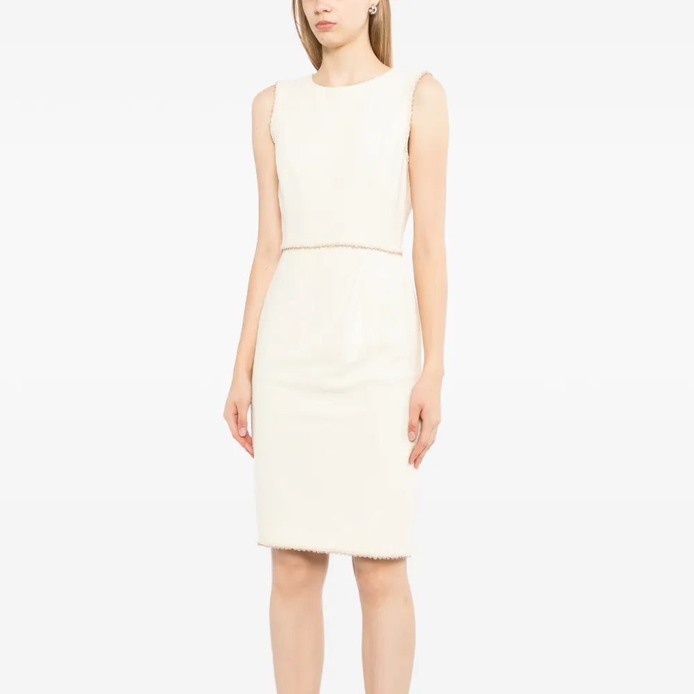 Chanel sleeveless cream wool tweed dress shown on a mannequin, featuring a fitted silhouette and classic tweed fabric.