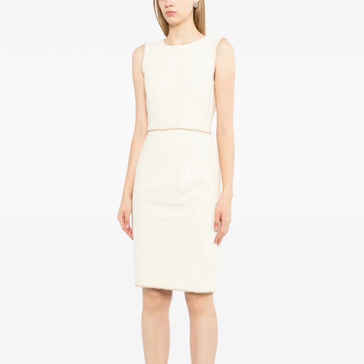 Chanel sleeveless cream wool tweed dress shown on a mannequin, featuring a fitted silhouette and classic tweed fabric.