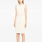 Chanel sleeveless cream wool tweed dress shown on a mannequin, featuring a fitted silhouette and classic tweed fabric.