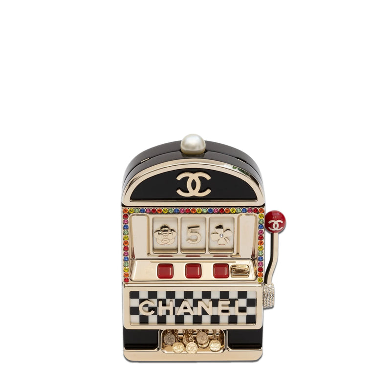 Chanel Slot Machine Casino Minaudière Clutch with black, cream and gold-tone slot machine design, CC logos, pearl-style top detail, rainbow crystal trim, checkerboard Chanel lettering, decorative lever and coin accents.