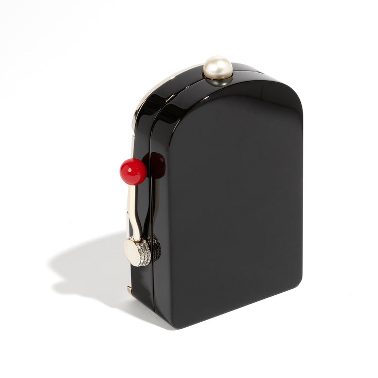 Chanel Slot Machine Casino Minaudière Clutch with black, cream and gold-tone slot machine design, CC logos, pearl-style top detail, rainbow crystal trim, checkerboard Chanel lettering, decorative lever and coin accents.