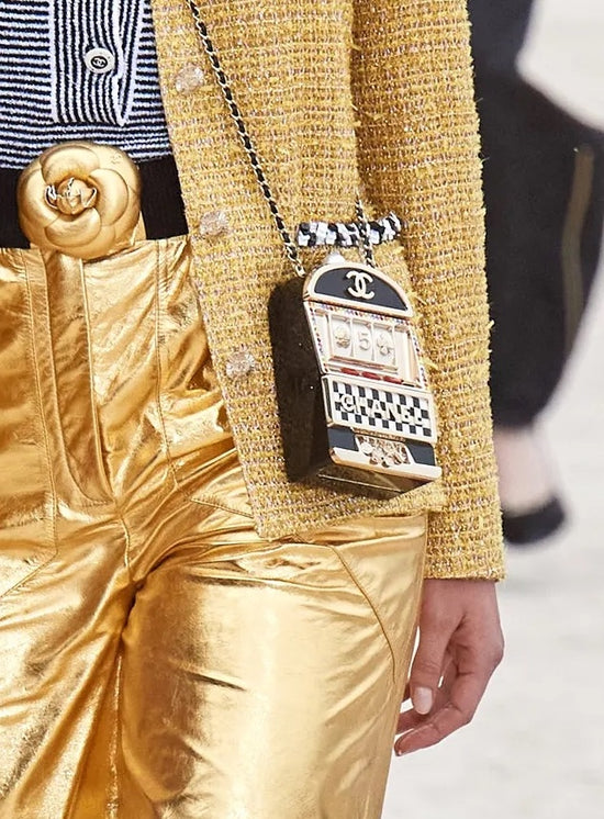 Chanel Slot Machine Casino Minaudière Clutch with black, cream and gold-tone slot machine design, CC logos, pearl-style top detail, rainbow crystal trim, checkerboard Chanel lettering, decorative lever and coin accents.