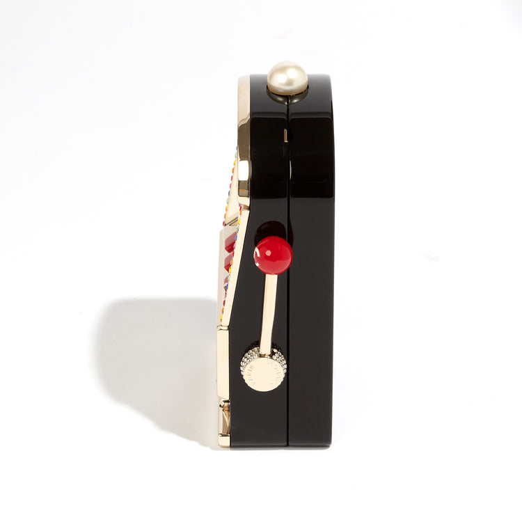 Chanel Slot Machine Casino Minaudière Clutch with black, cream and gold-tone slot machine design, CC logos, pearl-style top detail, rainbow crystal trim, checkerboard Chanel lettering, decorative lever and coin accents.