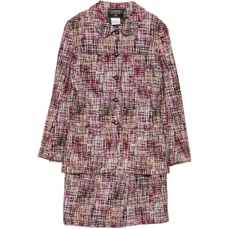 Chanel tweed skirt set featuring a fitted blazer and matching skirt, elegant and classic fashion ensemble.