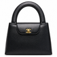 Chanel Vintage Kelly Bag from 1997–1999 in black caviar leather with 24K gold-plated CC hardware and structured double top handles.