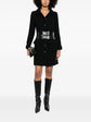 Chanel wool tweed coat with classic tailored fit, featuring a textured pattern and elegant design, perfect for sophisticated winter style.