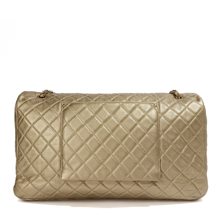 Metallic gold Chanel XXL airline travel flap bag with shoulder strap, side view showing textured surface and sleek design.