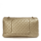 Metallic gold Chanel XXL airline travel flap bag with shoulder strap, side view showing textured surface and sleek design.