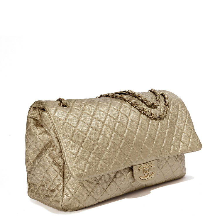 Metallic gold Chanel XXL airline travel flap bag with shoulder strap, side view showing textured surface and sleek design.
