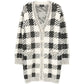 Black and cream houndstooth cashmere blend cardigan by Chanel, longline style, featuring classic pattern and cozy texture.
