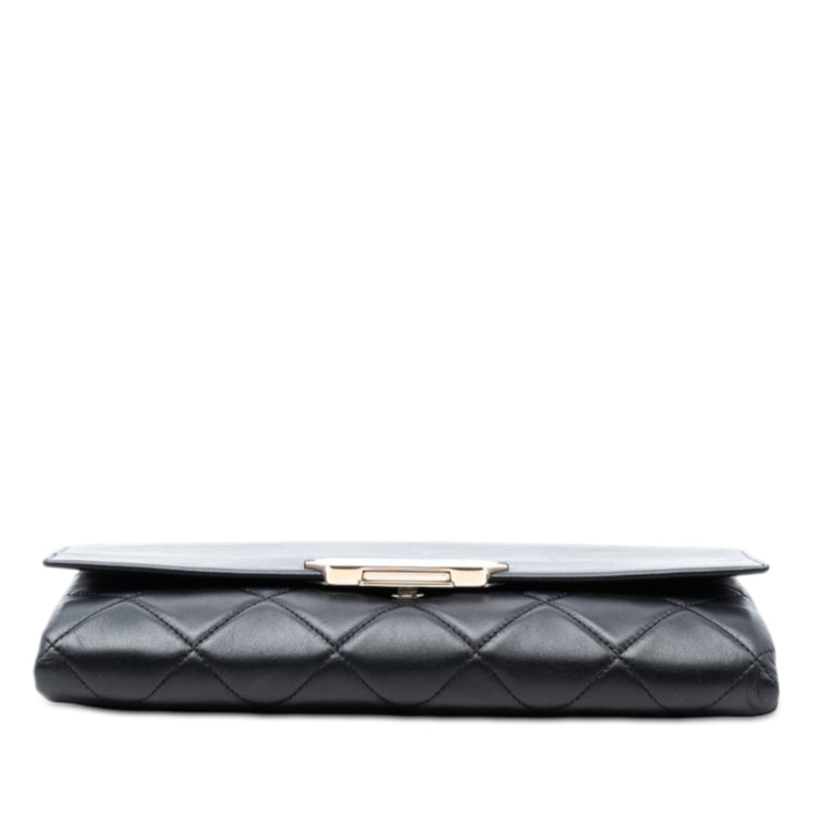 Chanel black quilted lambskin retro clutch bag with fold-over flap, front Chanel logo plaque, silver-tone chain detail and slim rectangular silhouette.