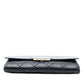 Chanel black quilted lambskin retro clutch bag with fold-over flap, front Chanel logo plaque, silver-tone chain detail and slim rectangular silhouette.