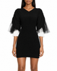 Black Chanel mini dress with rib knit fabric and tulle inset detailing, stylish and elegant for special occasions.