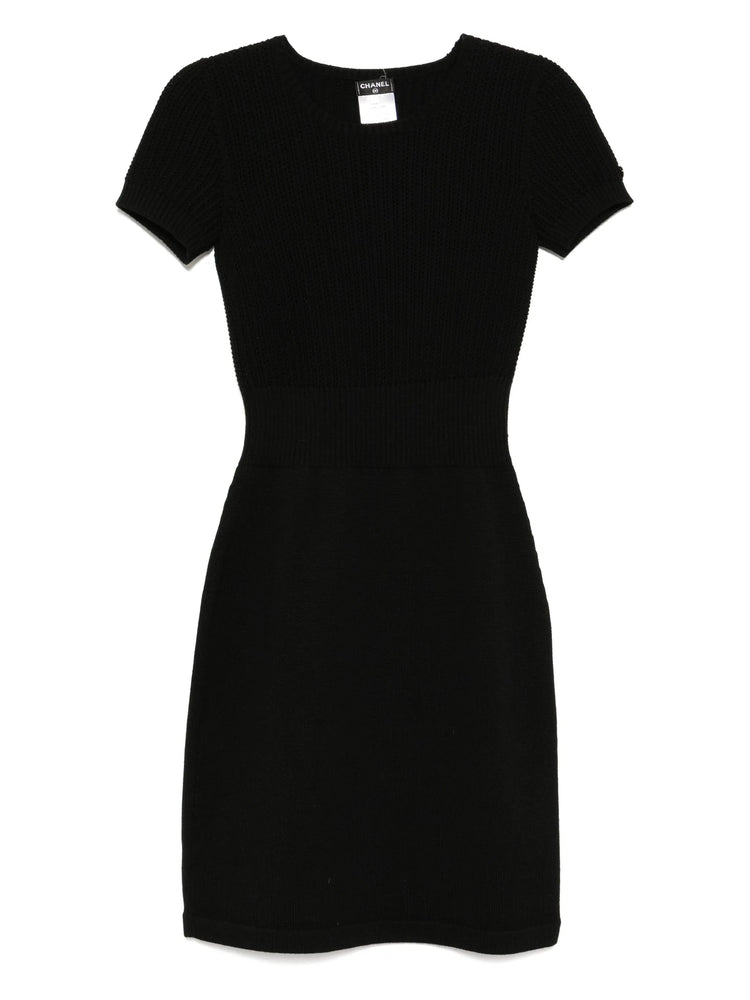 Black Chanel short-sleeve wool dress with a fitted silhouette, showcasing a classic elegant design perfect for stylish occasions.