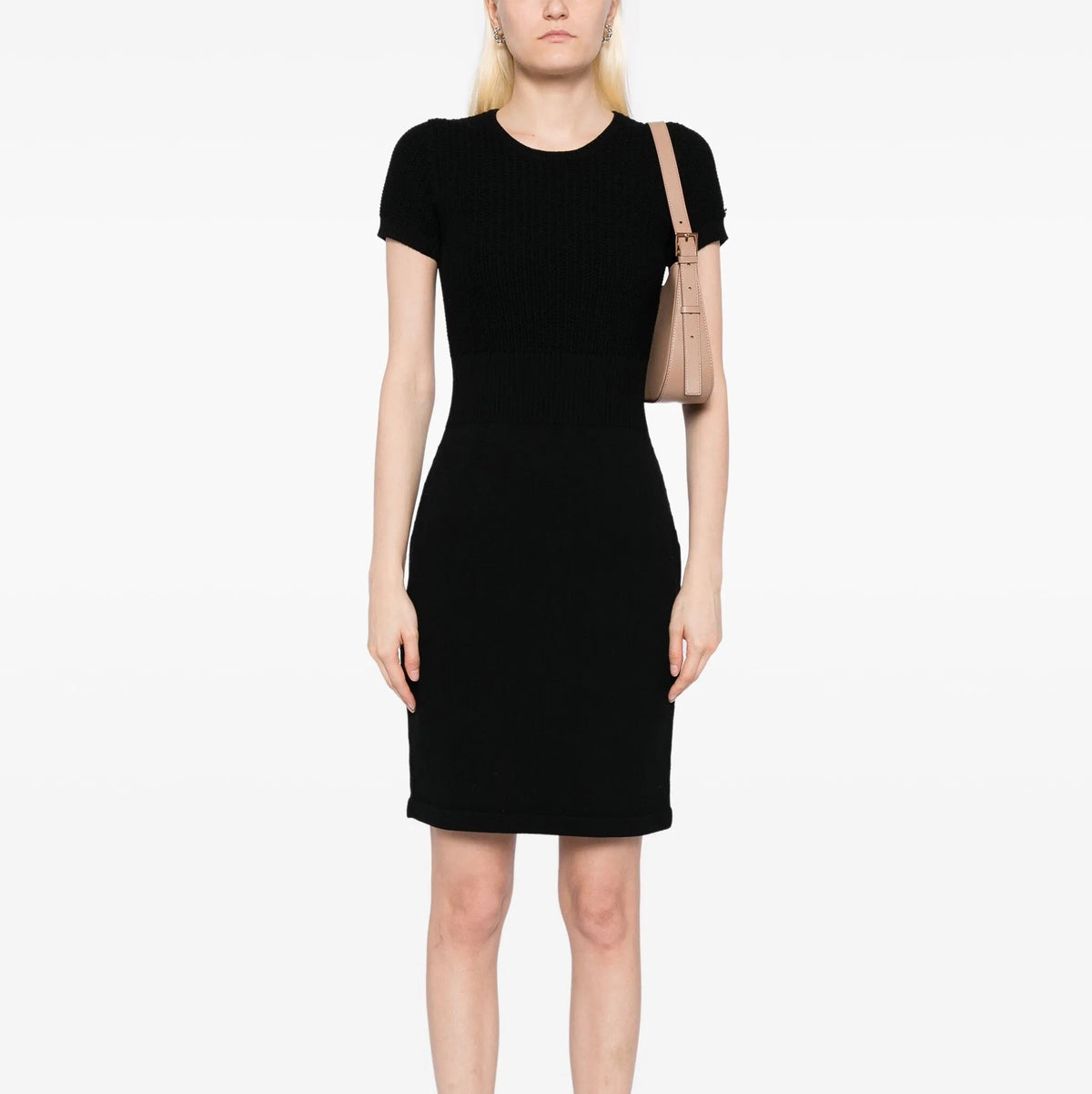 Black Chanel short-sleeve wool knit dress displayed on a hanger, showcasing its classic style and textured fabric.