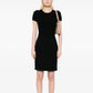 Black Chanel short-sleeve wool knit dress displayed on a hanger, showcasing its classic style and textured fabric.