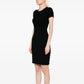 Black Chanel short-sleeve wool dress with a fitted silhouette and classic knit texture, displayed on a mannequin.