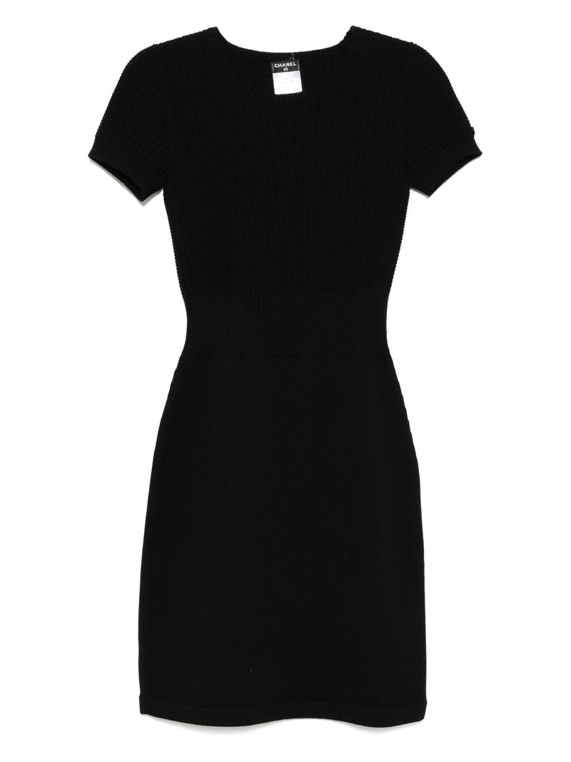 Black Chanel short-sleeve wool dress with a fitted silhouette, showcasing a classic elegant design perfect for stylish occasions.