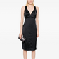 Black silk midi dress by Chanel, featuring elegant design and smooth fabric, perfect for sophisticated occasions.