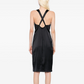 Black silk midi dress by Chanel, elegant dress with smooth fabric and classic design, showcased on a mannequin.