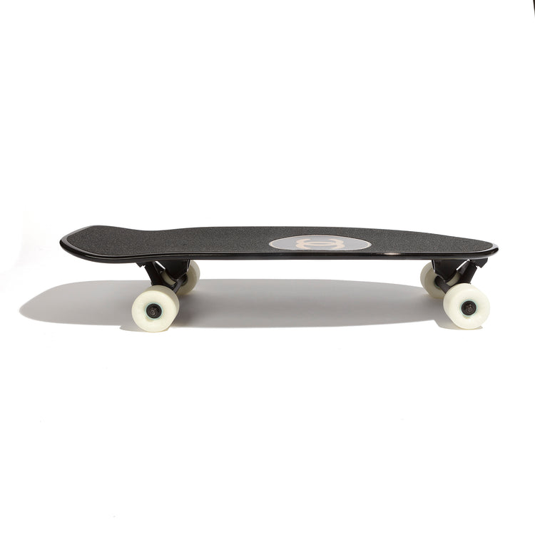 Chanel black skateboard deck with textured grip surface and large gold interlocking CC logo at the centre.