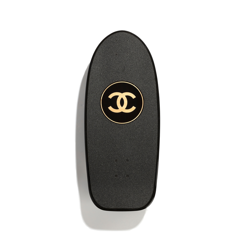 Black Chanel limited edition 2019 skateboard with stylish design, showcasing the iconic Chanel branding on a sleek object.