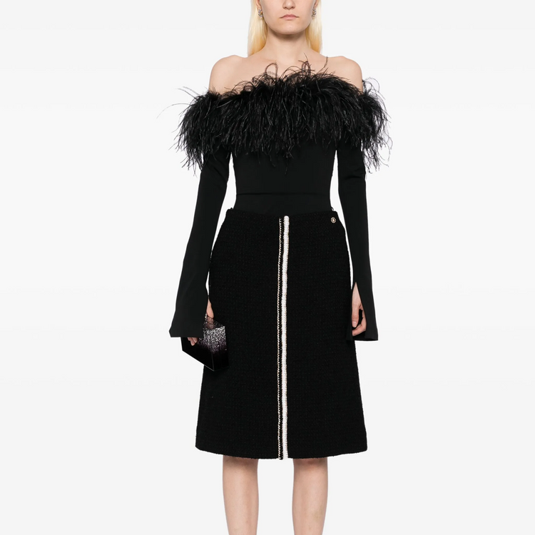 Black tweed skirt by Chanel, knee-length skirt with classic textured fabric, stylish and elegant for sophisticated fashion looks.
