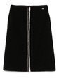 Black tweed skirt by Chanel, knee-length skirt from the 2020 collection, featuring classic tweed fabric and tailored fit.