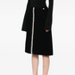 Black tweed Chanel skirt in knee-length style, featuring classic textured fabric and elegant design for stylish everyday wear.