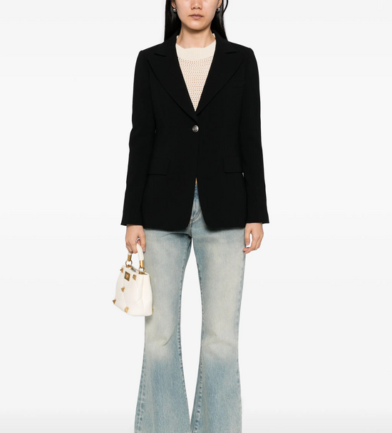 Chanel black wool blazer with tailored fit and classic lapel, stylish and versatile for formal or casual wear.