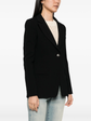 Chanel black wool blazer with classic tailored fit, front buttons, and lapel collar, stylishly displayed on a hanger.