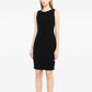 Black wool sleeveless sheath dress by Chanel, tailored fit with a sleek silhouette, displayed on a neutral background.