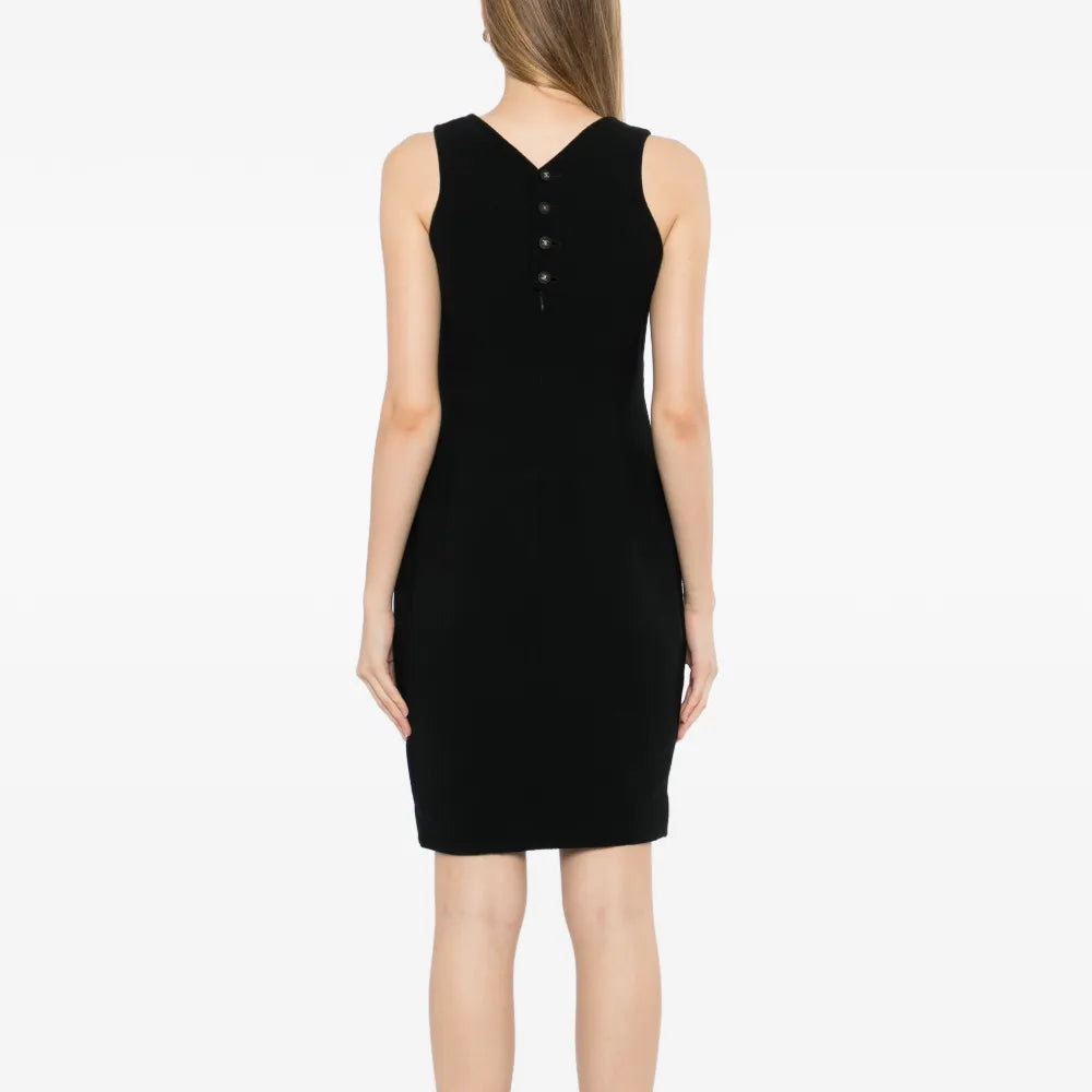 Black wool sleeveless sheath dress by Chanel, showcasing a fitted silhouette and elegant design on a model.